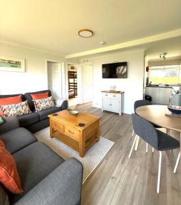 a living room with a couch and a table at 51 Norton Park in Dartmouth