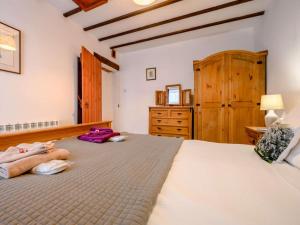 a bedroom with a large bed and a dresser at 1 Bed in Penrith oc-90417 in Kirkoswald