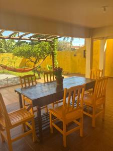 a wooden table and chairs with a potted plant on it at Morada 1000 - Pousada in Frutal