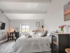 a white bedroom with a bed and a desk at 2 Bed in Ormskirk oc-90263 in Barton +21 photos