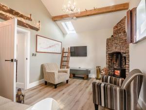 a living room with a fireplace and a tv at 2 Bed in Ormskirk oc-90263 in Barton