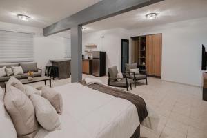 a bedroom with a large bed and a living room at 623 Boquerón Villas in Boqueron