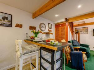 a kitchen with a table and chairs in a room at 1 Bed in Penrith oc-90416 in Kirkoswald