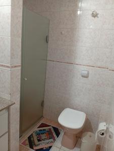 a bathroom with a toilet and a shower at Suite Sol I in Curitiba