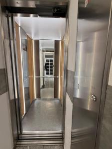 a hallway with a mirror in a building at Stay In Centre in Brno