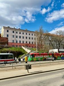a train on a street with a building in the background at Stay In Centre in Brno