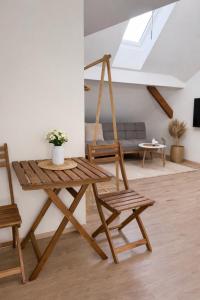 a living room with a wooden table and a swing at Ekoviki2 in Kranj