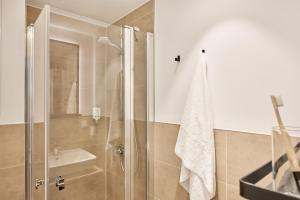 a bathroom with a shower and a toilet and a sink at appartello - smarttime living Berlin in Berlin +27 photos