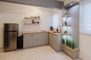a kitchen with a sink and a refrigerator at 623 Boquerón Villas in Boqueron
