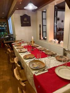 a long table with plates and glasses and a candle at Le Bois-Gentil in Gryon