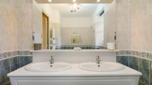 a bathroom with two sinks and a mirror at Mignonne en lisière de Brocéliande in Mauron +24 photos