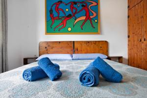 a bed with blue towels on top of it at Las Casitas 28 in Corralejo +20 photos