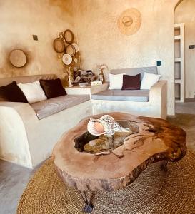 a living room with a tree stump coffee table at Uroa Sunset Bliss in Uroa