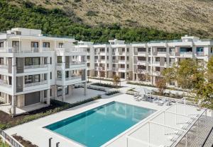 an aerial view of an apartment building with a swimming pool at River side apartment B3 in Herceg-Novi