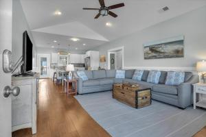 a living room with a blue couch and a tv at All Summer Long by Oak Island Accommodations in Oak Island