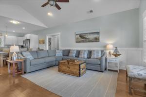 a living room with a blue couch and a table at All Summer Long by Oak Island Accommodations in Oak Island +31 photos