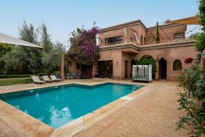 a house with a swimming pool in front of it at Villa Socar - Heated pool - Padel - Marrakech in Najem