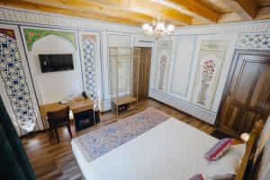 a bedroom with a bed and a chandelier at Imranbek Boutique Hotel in Bukhara