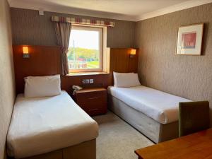 a hotel room with two beds and a window at The Park Hotel in Liverpool +42 photos