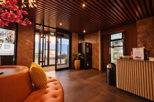 a lobby of a restaurant with a couch and a counter at Hotel Fogo Amsterdam in Amsterdam