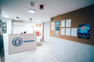 a reception area of a hospital with a sign on a wall at MadVibes Hostel Gran Vía in Madrid