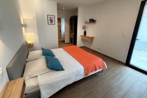 a bedroom with a large bed and a large window at Villa Dyane in Salavas +22 photos