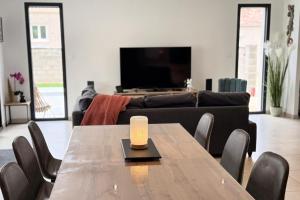 a living room with a table and a couch at Villa Dyane in Salavas