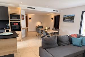 a living room and kitchen with a couch and a table at Villa Dyane in Salavas