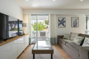 a living room with a couch and a table at Centralgarve - Amazing Apt in the Heart of Vilamoura in Vilamoura