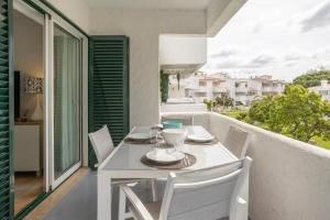 a white table and chairs on a balcony at Centralgarve - Amazing Apt in the Heart of Vilamoura in Vilamoura