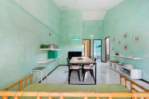 a room with a table and a blue wall at Casa Vacanze Bouganvillea in Sabaudia