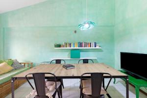 a dining room with a wooden table and chairs at Casa Vacanze Bouganvillea in Sabaudia