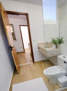 a bathroom with a toilet and a sink at Morada dos Ventos Búzios in Búzios +59 photos