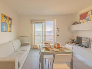 a living room with a couch and a table at EnjoyIseoLake - Lake View Paradise in Parzanica