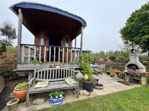 a house with a bench and a porch with a fireplace at Casa Otium in Genk
