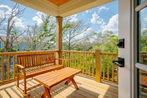 a wooden porch with a bench on a deck at All Sands On Deck by Oak Island Accommodations in Oak Island