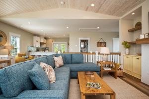 a living room with a blue couch and a table at All Sands On Deck by Oak Island Accommodations in Oak Island +95 photos