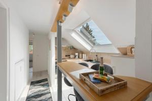 a kitchen and living room with a table and a window at Ferienwohungen Otto und Grete in Hemmoor