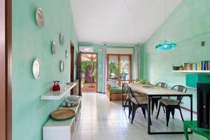 a dining room with a table and some chairs at Casa Vacanze Bouganvillea in Sabaudia