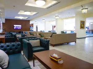 a waiting room with couches and chairs and a table at فندق بغداد Baghdad International Hotel in Baghdād