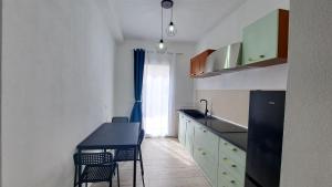 a kitchen with a black counter top and a table at Monte Ricco Appartamenti in Monselice