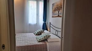 a bedroom with a bed with two pillows on it at Monte Ricco Appartamenti in Monselice