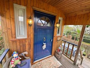 a blue door on a porch of a house at Casa Otium in Genk +11 photos