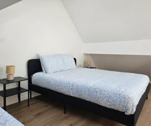 a bedroom with a bed with a blue comforter at Atomium Apartment 2 in Brussels