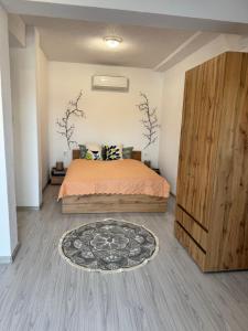 a bedroom with a bed and a wooden cabinet at Къща Елена in Yagoda