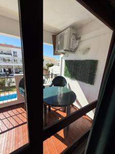a view of a balcony with a table and chairs at Apartamento Oura - Albufeira in Bicas +12 photos