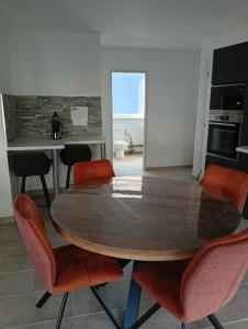 a dining room with a wooden table and chairs at Le logis de la liane in Boulogne-sur-Mer