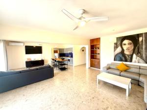 a living room with a couch and a tv at Latchi Marina in Lachi