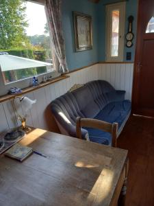 a living room with a couch and a table at Casa Otium in Genk