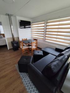 a living room with a couch and a table at Cabañas Terravento in Puerto Natales